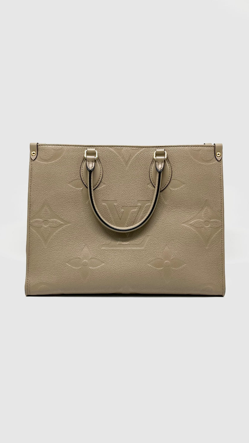 Preowned. LV On The Go MM Empreinte Dove Gray. Microchip|14584