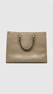Preowned. LV On The Go MM Empreinte Dove Gray. Microchip|14582