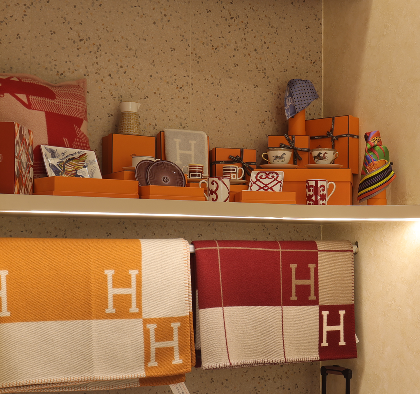 Curated Hermès scarves, blankets, tableware, and luxury accessories displayed at The Orange Box, a luxury boutique in BGC, Philippines.