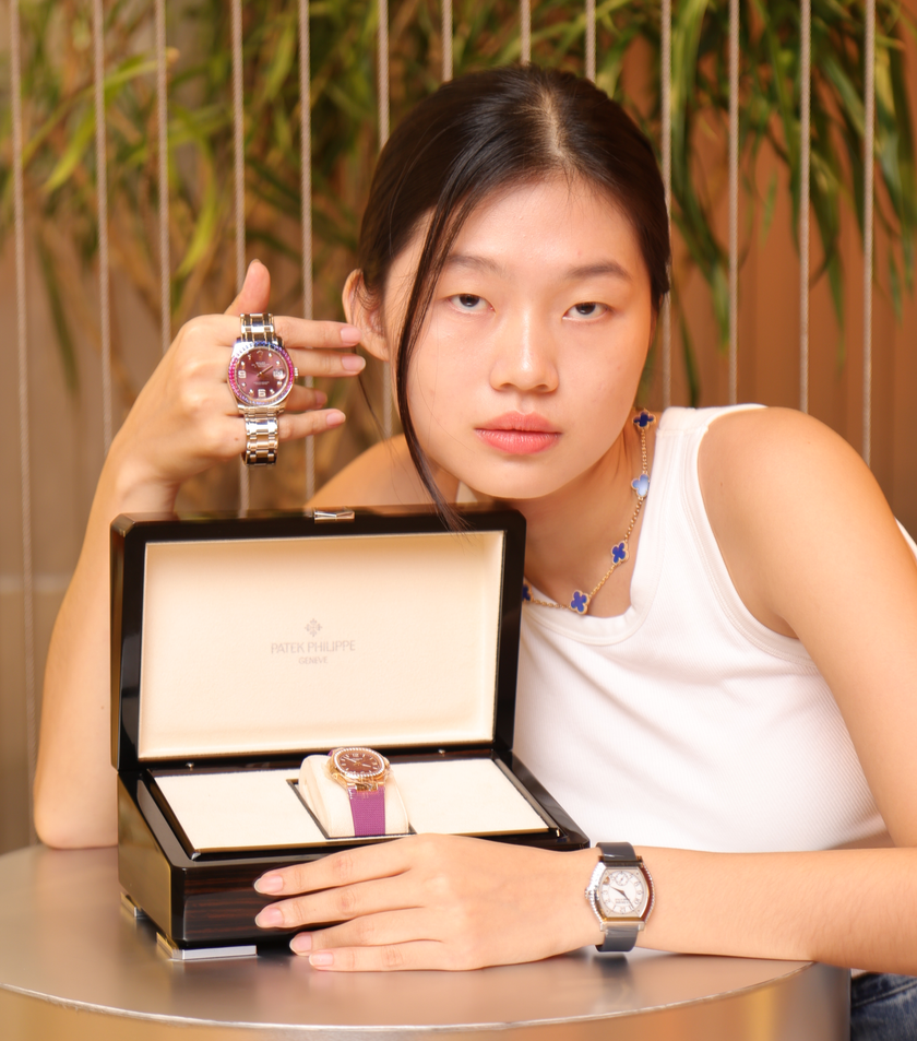 Model showcasing a collection of luxury watches, including Patek Philippe, for The Orange Box, a luxury boutique in BGC, Philippines.
